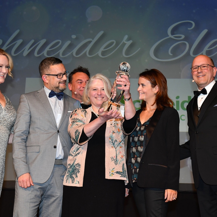 woman receiving award with other people